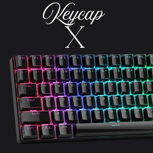 May include: A black mechanical keyboard with illuminated keys. The keys are backlit with a rainbow gradient. The top of the image has the text "Keycap X" in white script.