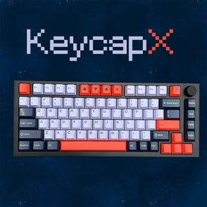 Könnte beinhalten: Eine schwarze und graue mechanische Tastatur mit weißen, orangefarbenen und lila Tastenkappen. Die Tastatur hat verschiedene Funktionstasten und einen Ziffernblock. Der Text "KeycapX" wird über der Tastatur angezeigt.