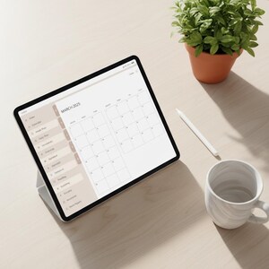 May include: A digital tablet displaying a March 2025 calendar, with a white stylus and a marble-patterned mug on a light wood surface. A small potted plant sits nearby. The tablet's interface includes menu options.