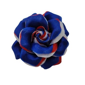 May include: A blue, white, and red fabric rose. The rose is made of fabric that is striped in these colors.