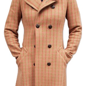May include: A double-breasted, long-sleeved coat with a pink and beige plaid pattern. The coat has a collar and pockets. A red flower pin is on the lapel.