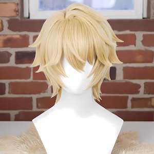 May include: A light blonde wig with layered, textured styling. The wig features a short, choppy cut with longer pieces framing the face. The wig is displayed on a white mannequin head against a brick wall background.