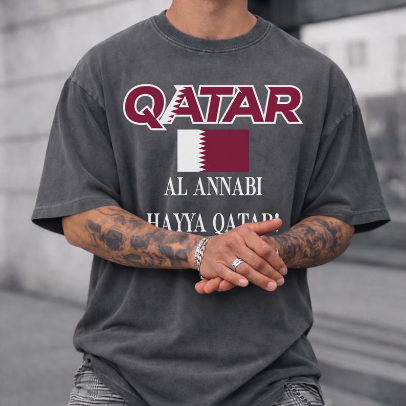 Pepper T-shirt featuring maroon Qatar typography, national flag, and Al Annabi football fan design.