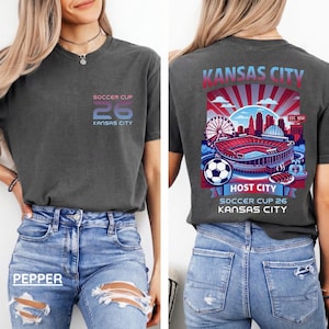 Lifestyle mockup of a woman in a pepper-grey t-shirt and denim jacket, highlighting the vibrant red and blue sports graphic.