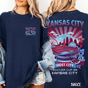 Front and back view of a woman in a navy blue t-shirt showcasing the detailed retro Kansas City Host City design.