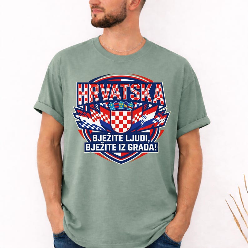 Moss premium garment-dyed t-shirt with a bold Croatian national shield and football team spirit print, shown on a bearded male model.