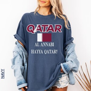 Navy blue T-shirt showcasing the Qatar flag and Al Annabi match day soccer apparel print.