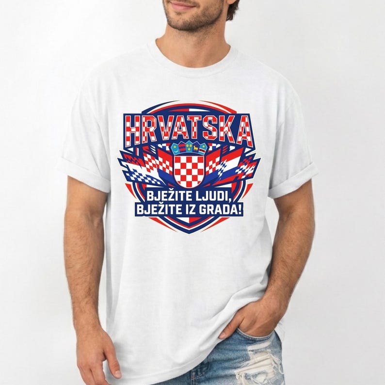 May include: White t-shirt featuring a Croatian design. The design includes the word "HRVATSKA" in red and blue, along with a Croatian coat of arms and the text "BJEŽITE LJUDI, BJEŽITE IZ GRADA!" in blue. The shirt is a casual wear item.