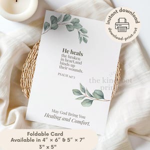 May include: A white rectangular card featuring watercolor eucalyptus leaves at the top and bottom. The text reads: He heals the broken in heart, and binds up their wounds. PSALM 147:3. May God Bring You Healing and Comfort. Available in 4" x 6", 5" x 7", and 3" x 5".