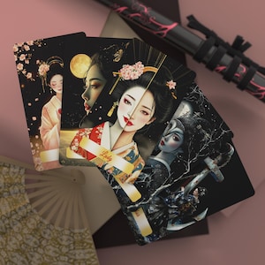 May include: A set of four tarot cards with black backgrounds and colorful illustrations of women in traditional Japanese clothing. The cards feature a variety of floral and geometric patterns, as well as the words "Lady" and "The World".