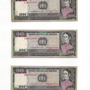 May include: Three vintage 1000 Bolivianos banknotes. Each bill features a portrait of a man in a pink jacket and the text "BANCO CENTRAL DE BOLIVIA". The bills have serial numbers and the denomination "1000" in multiple places.