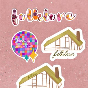 May include: A selection of stickers on a pink background. The stickers feature the word "folklore" in a floral design, a house illustration, and a circular sticker with the text "Shinning just for you."