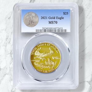May include: A 2021 Gold Eagle MS70 coin in a clear protective case. The gold coin displays an eagle design and the words "United States of America". The holder has a label with the text "2021 Gold Eagle MS70".