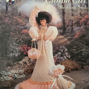 May include: A crochet doll pattern for a Gibson Girl in a white and peach strolling suit. The pattern is designed by Mae Meats and is titled "1893 Gibson Girl Strolling Suit".