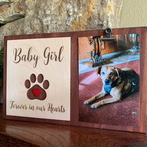 May include: A wooden photo frame with a cutout paw print and a red heart. The frame has a photo of a brown dog and the text "Baby Girl Forever in our Hearts".