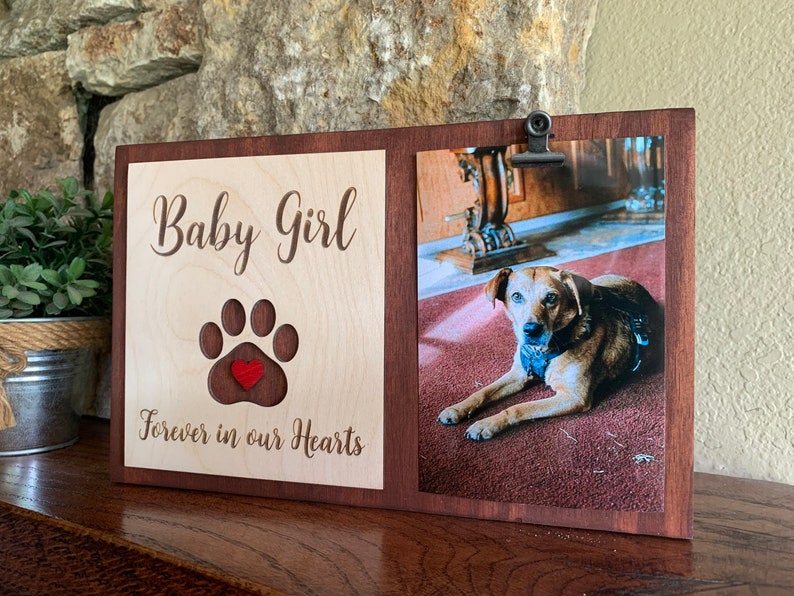 May include: A wooden photo frame with a cutout paw print and a red heart. The frame has a photo of a brown dog and the text "Baby Girl Forever in our Hearts".