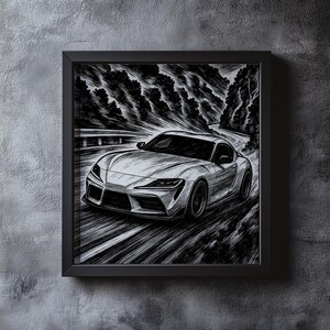 May include: Black and white framed artwork of a sports car speeding along a winding road through a forest. The car is the focal point, rendered in detailed lines, with the background trees and road adding depth and motion.