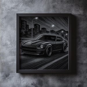 May include: Black and white framed print of a classic sports car driving on a road at night. The artwork depicts the car with detailed shading, set against a cityscape with streetlights and buildings in the background. The frame is black.