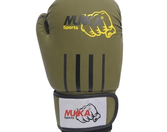 May include: Olive green boxing glove with black stripes and a white wrist strap. The glove features the text "NUKKA Sports" and a yellow fist graphic. The wrist strap has the text "NUKKA Sports" and "16oz".