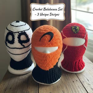 May include: Three unique crochet balaclavas on display. One is white with black accents, another is orange with a black design, and the third is red with a white stripe and a logo. The text on the image says "Crochet Balaclava Set - 3 Unique Designs."