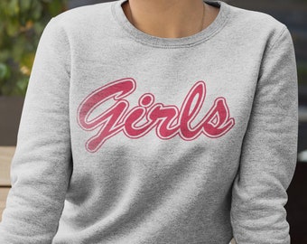 May include: A gray sweatshirt with the word "Girls" printed in pink on the front.