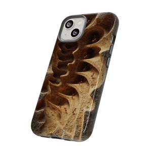 May include: A phone case with a brown and tan abstract design featuring a close-up of an ant colony. The case has a camera cutout and a black border.
