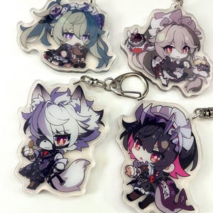 May include: Four anime-style character keychains. Each keychain features a unique chibi design with detailed outfits and accessories. The characters have large eyes and are in various poses. The keychains are attached to silver-colored metal clasps.