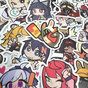 May include: A collection of die-cut vinyl stickers featuring various anime-style characters with colorful hair, expressive faces, and diverse outfits. The stickers display a range of poses, including holding objects like red envelopes, food, and tools.