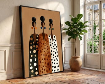 May include: A framed rectangular wall art piece featuring a stylized illustration of three figures with dark skin and high buns, wearing long, patterned dresses in black, brown, and white, accented by large, colorful circular earrings.