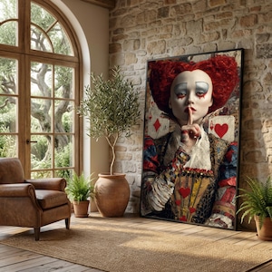 May include: A framed art print featuring a portrait of a person with red hair styled in a heart shape, finger to lips. The person is wearing a detailed costume with playing card imagery. The background includes playing cards and a brick wall.
