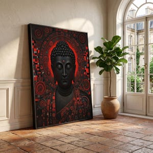 Puede incluir: Una obra de arte enmarcada que presenta un Buda negro con un halo rojo y patrones intrincados. La obra es predominantemente negra y roja, con un diseño detallado alrededor de la cabeza del Buda. Se apoya en una pared blanca.
