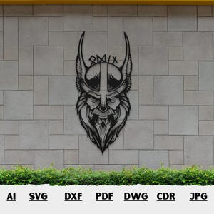 May include: Black metal wall art depicting a Viking warrior's face with a horned helmet and intricate beard. The artwork is mounted on a light gray brick wall. The image also includes file type abbreviations: AI, SVG, DXF, PDF, DWG, CDR, and JPG.