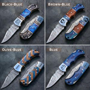 May include: Four folding pocket knives with various handle designs and blade patterns. The handles feature combinations of black, brown, olive, and blue, with decorative inlays. Each knife has a unique blade pattern and personalized engraving.