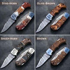 May include: Four folding knives with different handle designs and blade patterns. The handles are labeled "STAG-HORN", "OLIVE-BROWN", "SHEEP-HORN", and "BROWN". Each knife has a personalized inscription on the handle and blade.