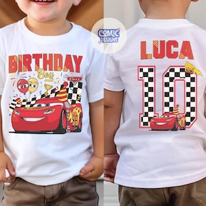 May include: White t-shirt with a red "BIRTHDAY BOY" graphic and a cartoon race car design. The back of the shirt features the name "LUCA" and the number "10" with a checkered flag design. A fun birthday shirt.