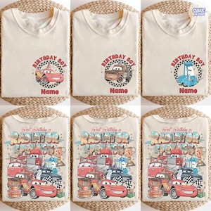 May include: Cream-colored t-shirts with colorful graphic designs featuring characters from the movie Cars. The shirts have the text "Birthday Boy" and "Name" or "Best Birthday in Radiator Springs". The designs include race cars and birthday elements.