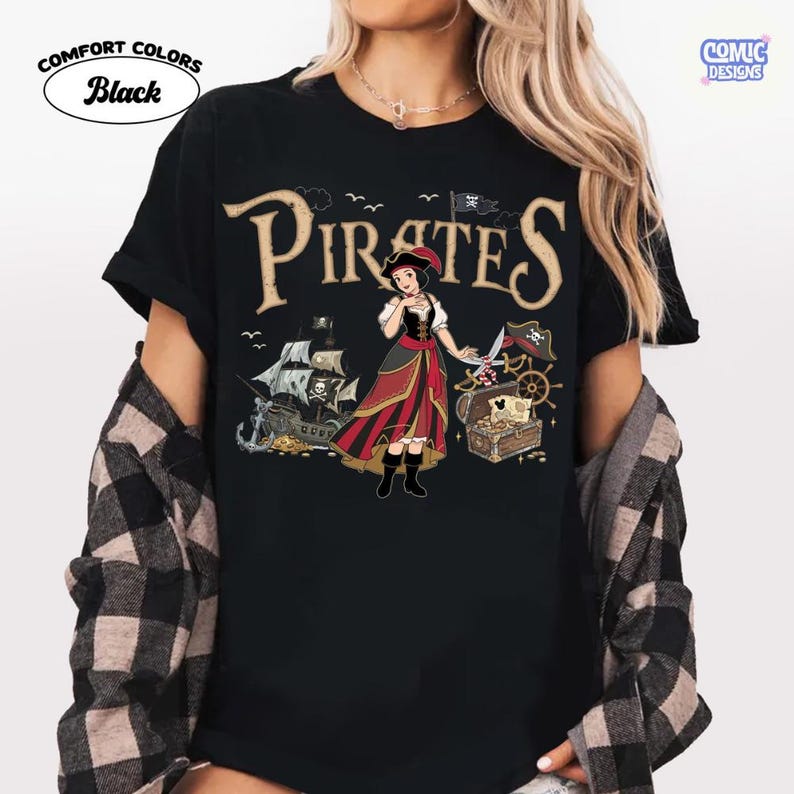 May include: Black Comfort Colors t-shirt with a "Pirates" graphic. The design features a cartoon pirate character, a treasure chest, a pirate ship, and the text "Pirates".