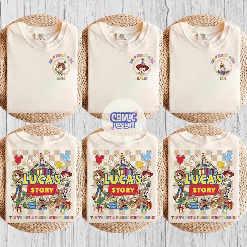 May include: Six cream-coloured t-shirts. The top row features "Birthday Girl" designs with cartoon characters. The bottom row displays "Lucas's Story" designs with multiple characters and text. The shirts are arranged on woven mats.