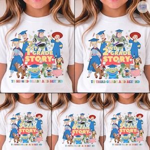 May include: White t-shirt featuring a colorful graphic of animated characters and the text "1st Grade Story" with "To Second Grade and Beyond" below. The design includes characters from a popular animated movie.