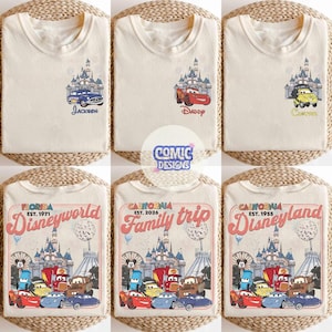 K&ouml;nnte beinhalten: Cremefarbene T-Shirts mit verschiedenen Designs. Einige zeigen ein Schloss und Zeichentrickautos mit Namen wie "Jackson", "Daddy" und "Carson". Andere zeigen Grafiken von "Florida Disneyworld" und "California Family trip".