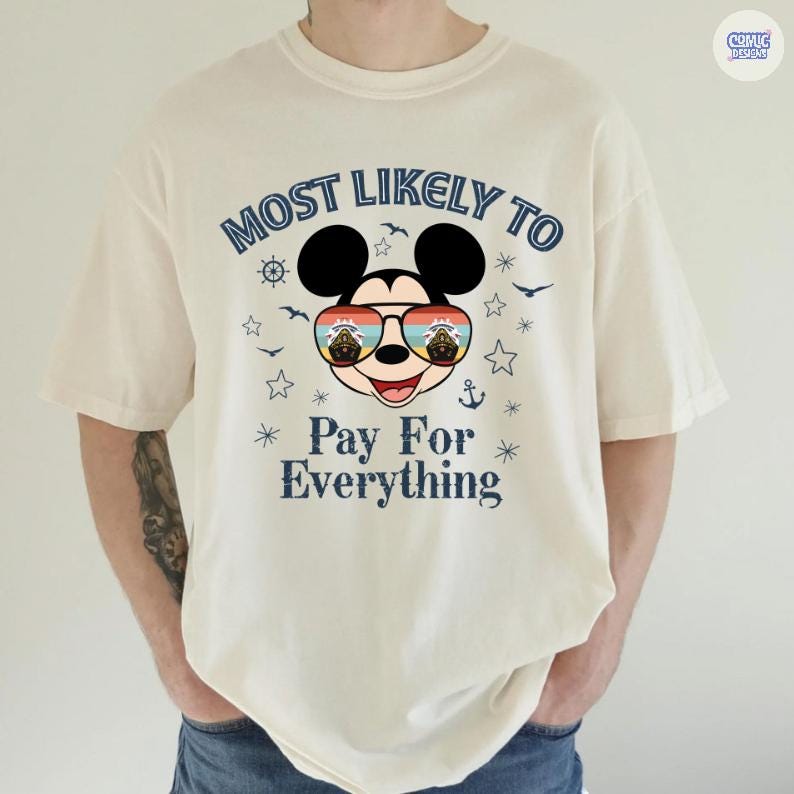 May include: Cream-colored t-shirt featuring a graphic of Mickey Mouse wearing sunglasses with a sunset design. The text "MOST LIKELY TO Pay For Everything" is printed above and below the character in navy blue.