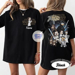 May include: Black t-shirt featuring a Star Wars and Disney mashup design. The front displays a character with the text "Star Wars" and "Name". The back showcases various characters, the Millennium Falcon, and the text "Star Wars".