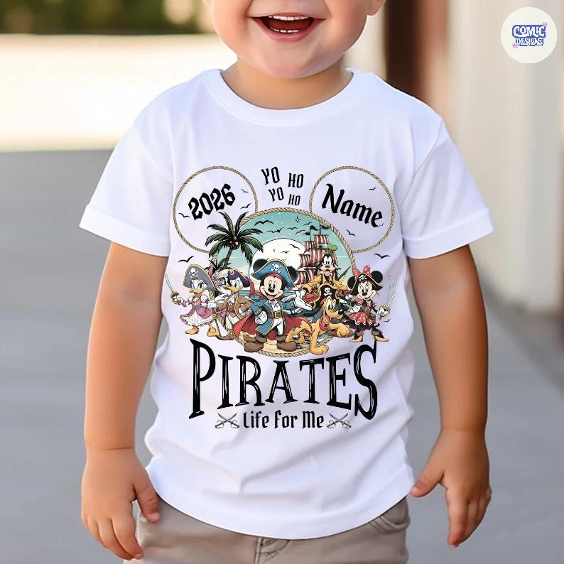May include: White t-shirt featuring a colorful graphic of Disney characters dressed as pirates. The design includes the word "PIRATES" in a bold font, the year "2026", and the phrase "Life for Me". The shirt has a round neckline and short sleeves.