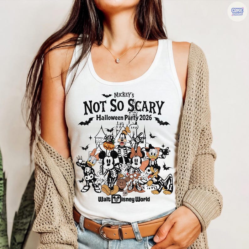 May include: White tank top featuring a graphic for Mickey's Not So Scary Halloween Party 2026 at Walt Disney World. The design includes various Disney characters in Halloween costumes, with bats and a castle silhouette.