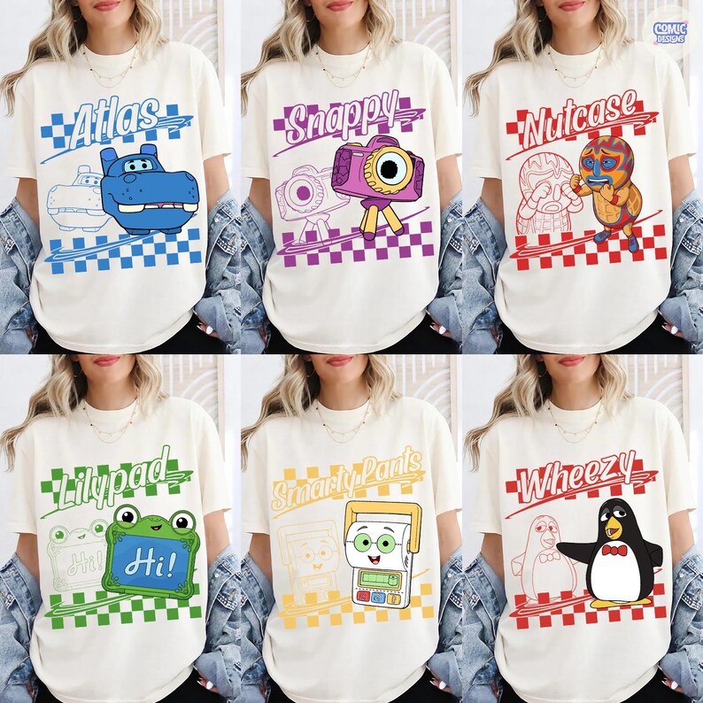 May include: A collection of six off-white t-shirts featuring cartoon characters and names: Atlas with a blue hippo, Snappy with a purple camera, Nutcase with a wrestler, Lilypad with a green frog, Smarty Pants with a calculator, and Wheezy with a penguin.