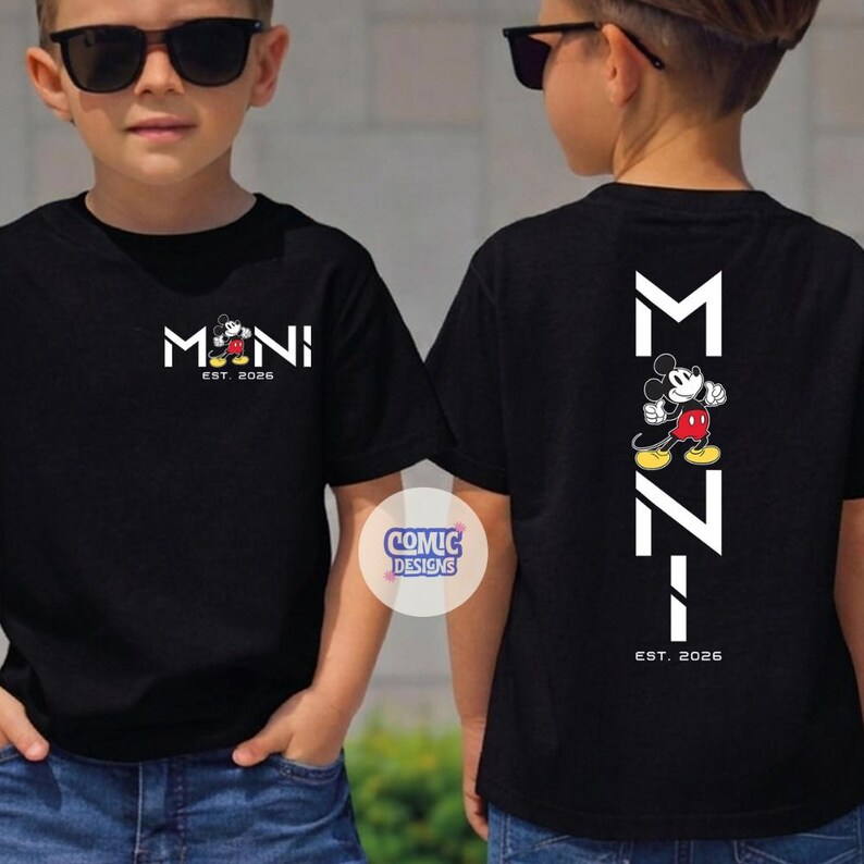May include: Black t-shirts with a Mickey Mouse design. The front of the shirt has the word "MONI" with Mickey Mouse in the middle and the text "EST. 2026". The back of the shirt has the letters "M Z I" with Mickey Mouse in the middle and the text "EST. 2026".