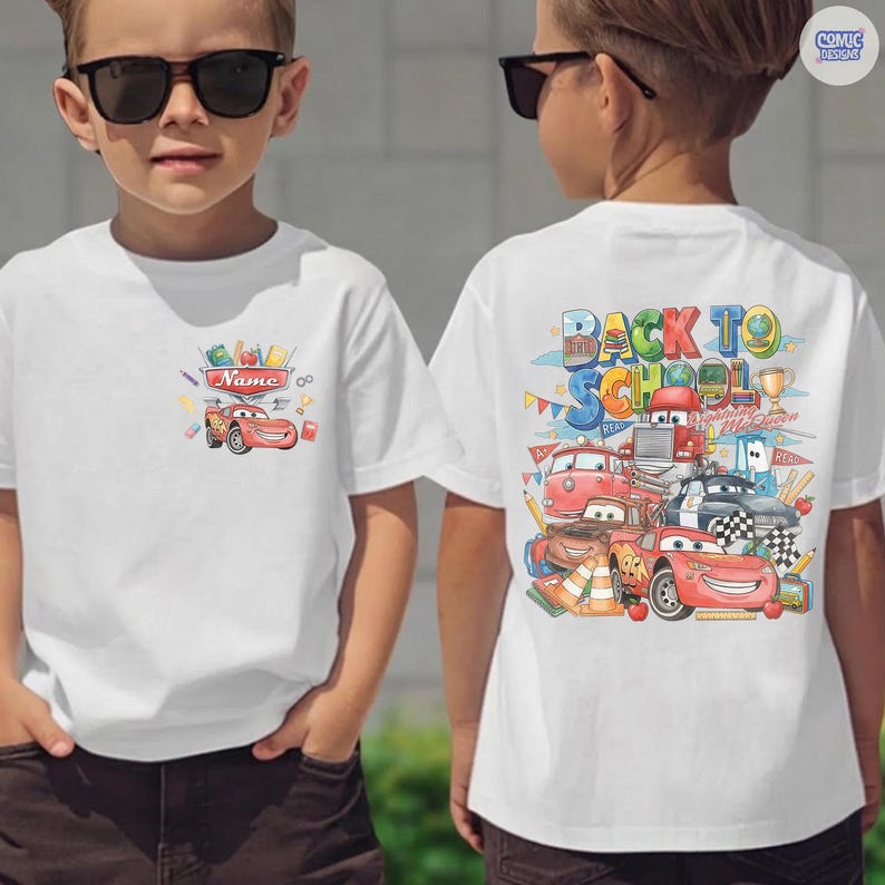 May include: A white t-shirt featuring a small graphic on the front chest of a red race car and school supplies with a name banner. The back displays a large colorful illustration of multiple race cars, school supplies, and the text Back To School.