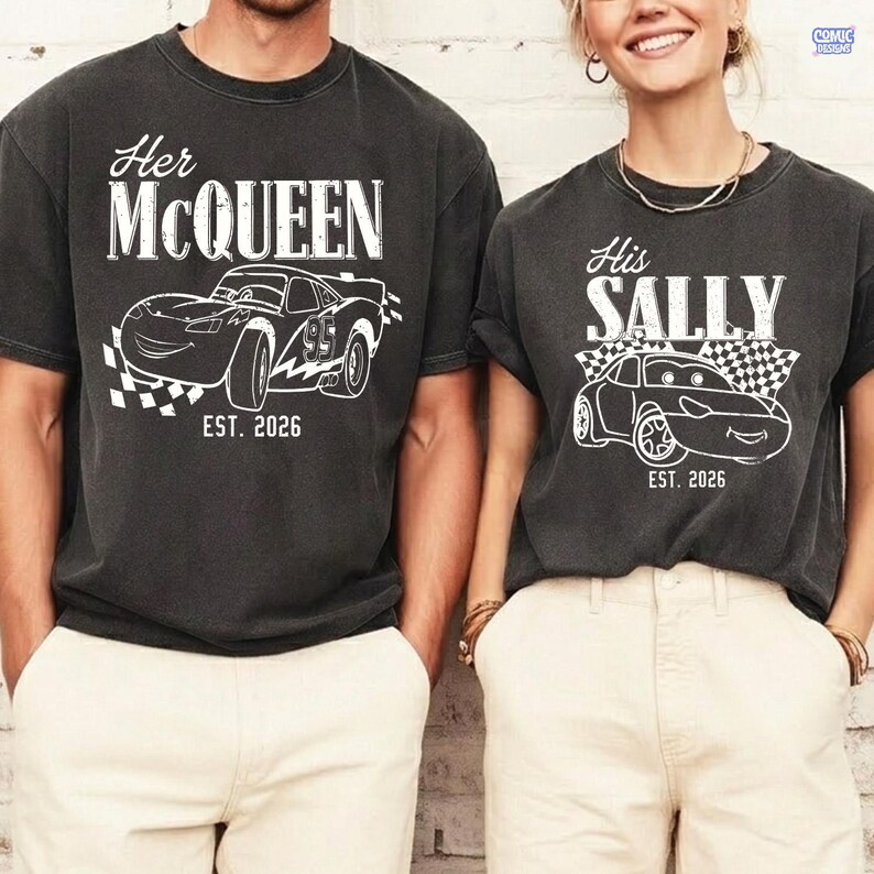May include: Two charcoal gray t-shirts with white graphics. One shirt says "Her McQueen" with a race car illustration and "EST. 2026". The other says "His Sally" with a car illustration and "EST. 2026".