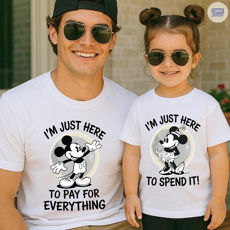 May include: Two white t-shirts with matching Mickey and Minnie Mouse designs. The adult's shirt says "I'M JUST HERE TO PAY FOR EVERYTHING," while the child's shirt reads "I'M JUST HERE TO SPEND IT!" Both shirts feature a cartoon image of the character.