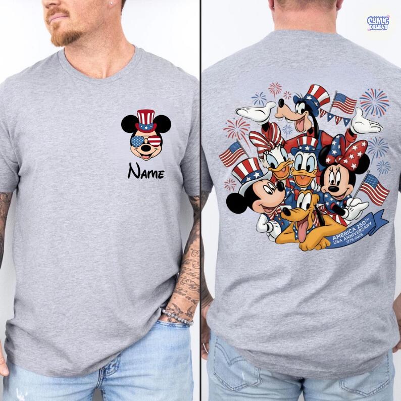 May include: A gray t-shirt featuring Mickey Mouse in patriotic attire with sunglasses and a hat. The text "Name" is below the graphic. The back of the shirt displays a group of Disney characters celebrating with flags and fireworks.
